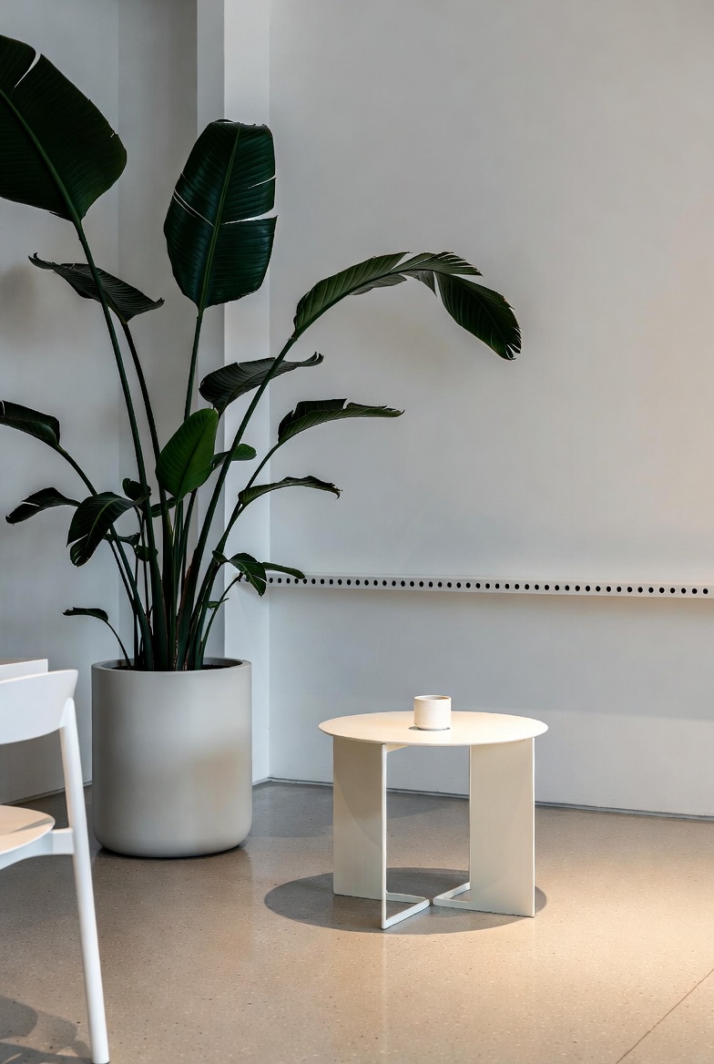 Lobby with concrete walls, benches, and grouped planters